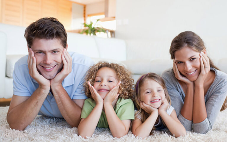 family lying on carpet