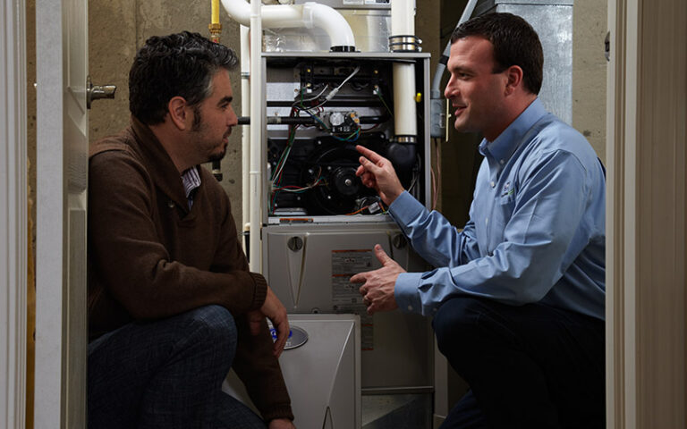homeowner talking to technician about furnace